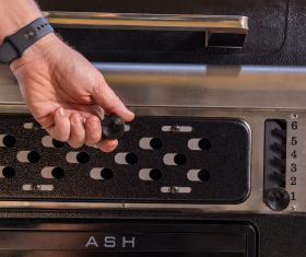 Charcoal grill with adjustable grate.