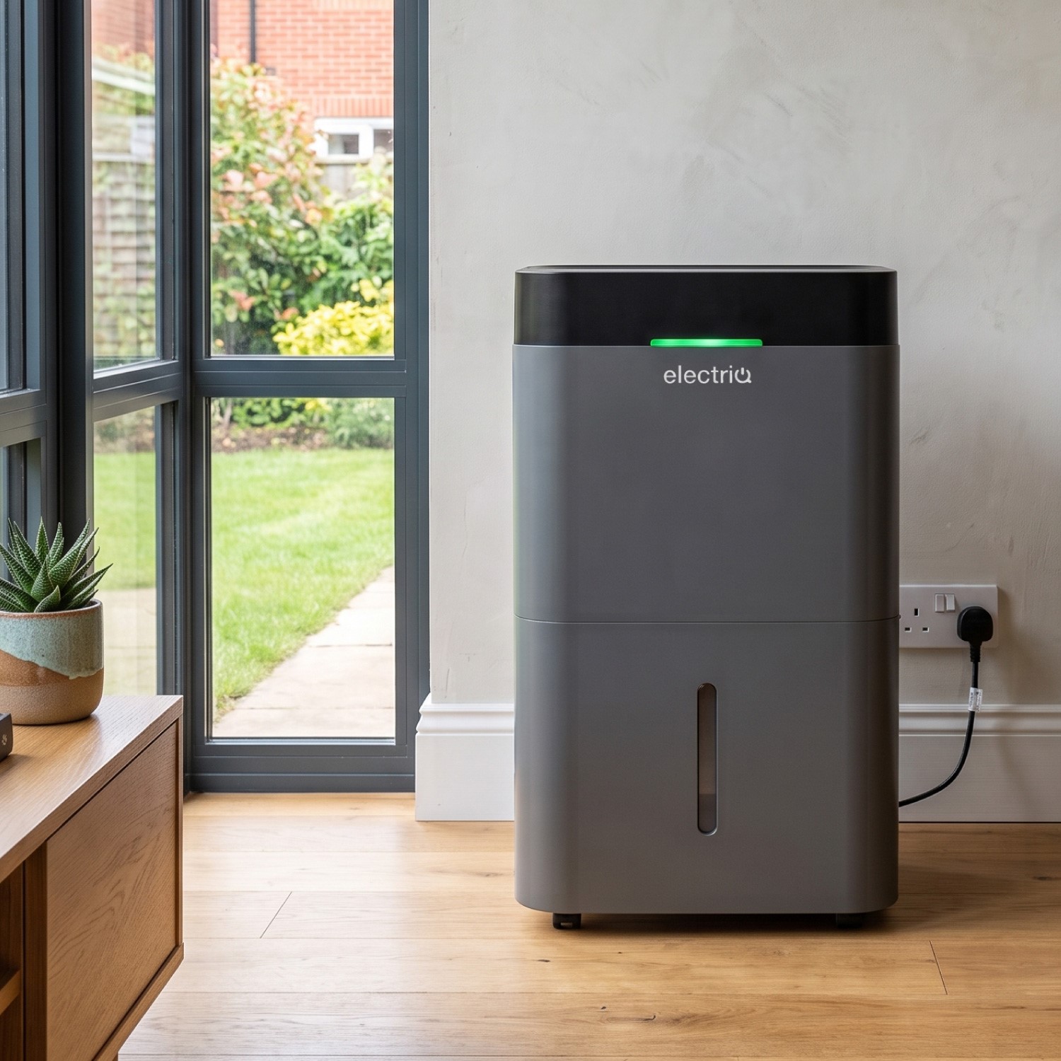 electriQ CD35LECOPLUS dehumidifier in a living room with the green humidity indicator lit.