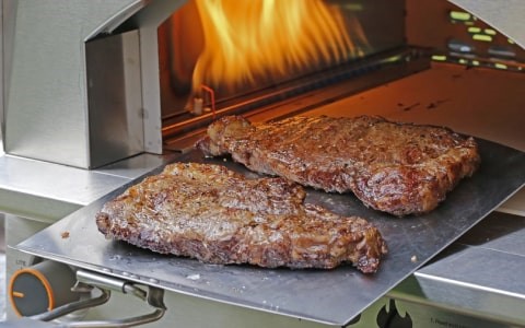 Steak cooking in pizza oven