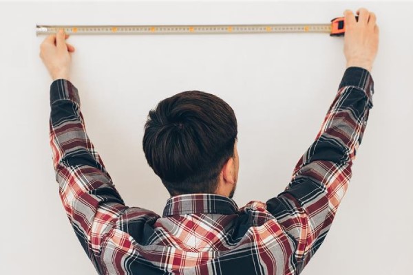 Measuring tape showing room dimensions for radiator sizing