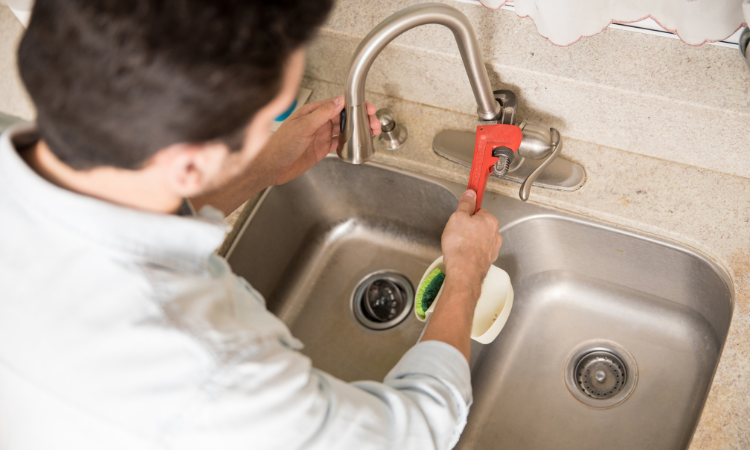 Hands installing a kitchen boiling water tap
